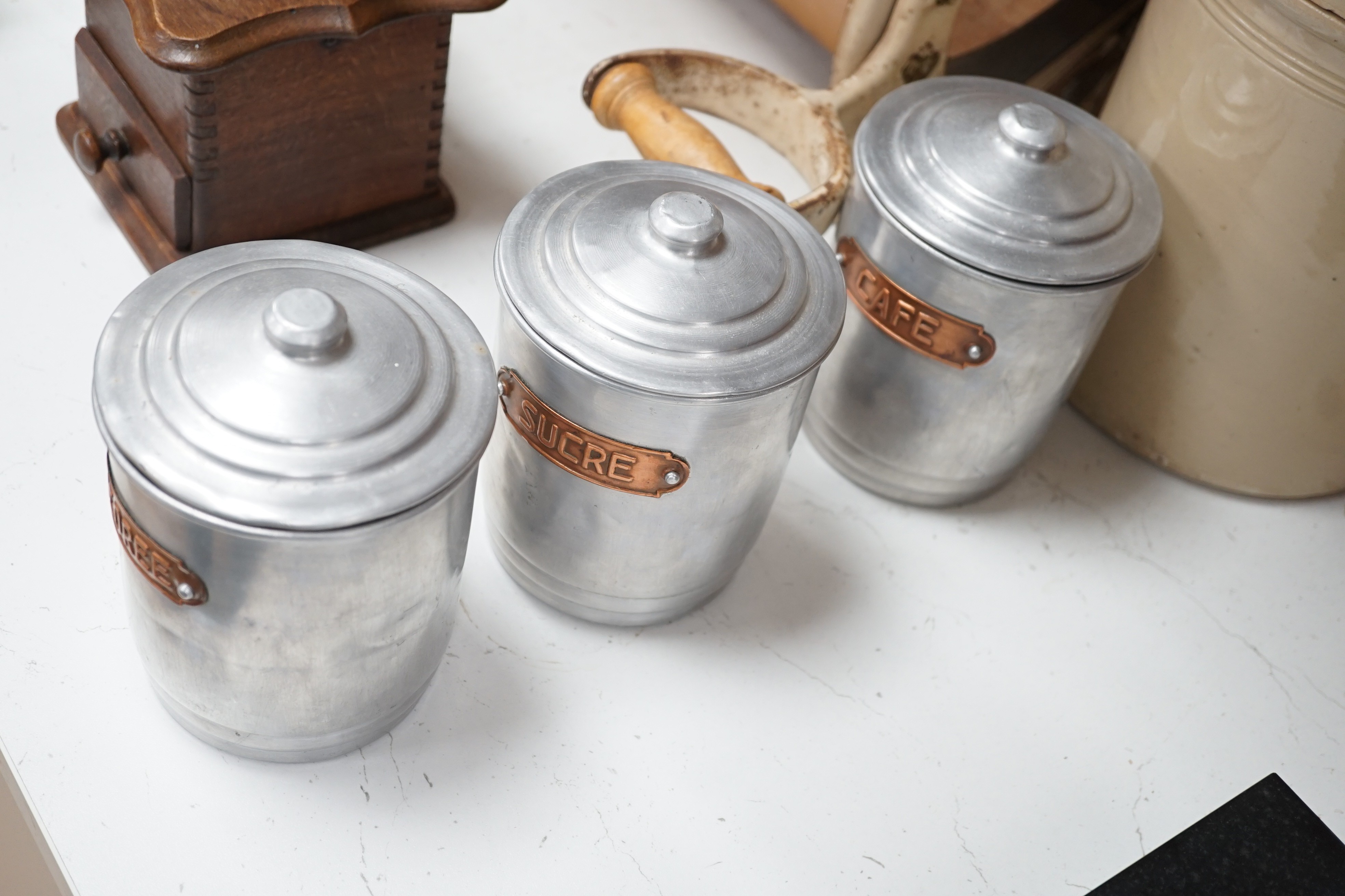 Kitchenalia: A group of French ceramic storage jars and metal canisters, a Danish bread slicer, a French coffee grinder and a croc and cover, bread slicer 31cms wide